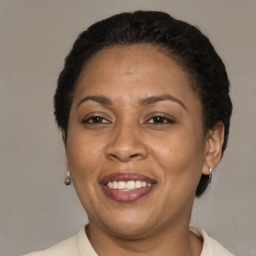 Joyful latino adult female with short  brown hair and brown eyes