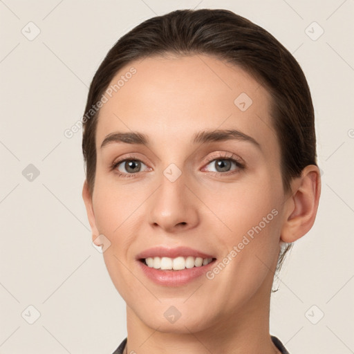 Joyful white young-adult female with short  brown hair and grey eyes