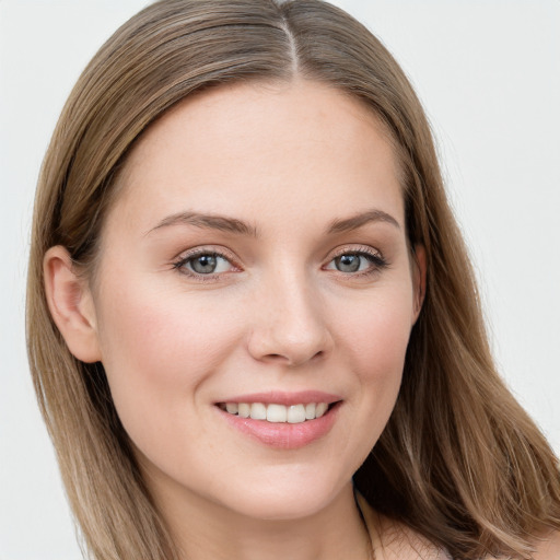 Joyful white young-adult female with long  brown hair and blue eyes