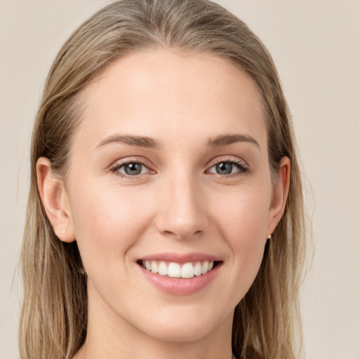 Joyful white young-adult female with long  brown hair and grey eyes