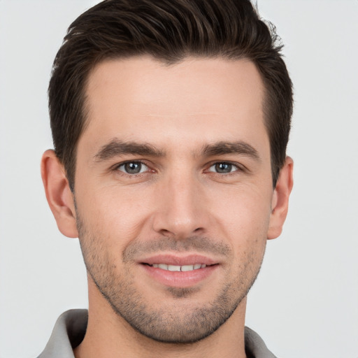 Joyful white young-adult male with short  brown hair and brown eyes