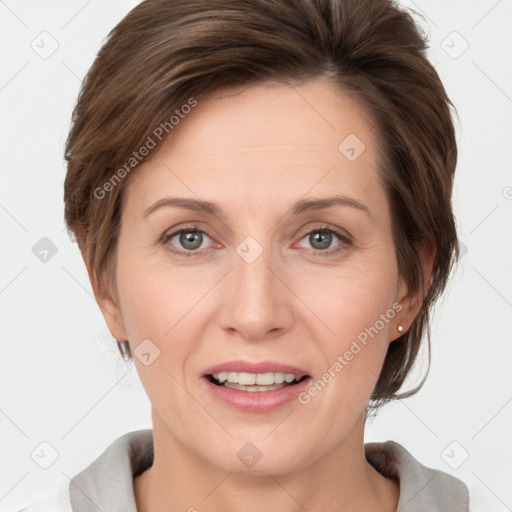 Joyful white adult female with medium  brown hair and grey eyes