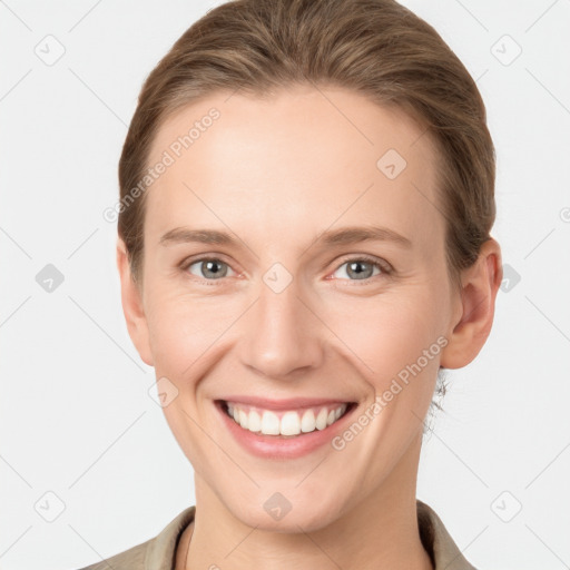 Joyful white young-adult female with short  brown hair and grey eyes