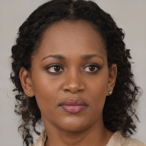 Joyful black young-adult female with medium  brown hair and brown eyes