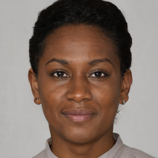 Joyful black young-adult female with short  brown hair and brown eyes