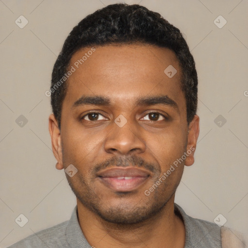 Joyful black young-adult male with short  black hair and brown eyes