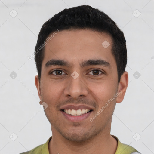 Joyful latino young-adult male with short  black hair and brown eyes