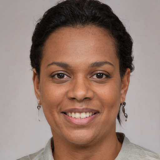 Joyful latino adult female with short  brown hair and brown eyes