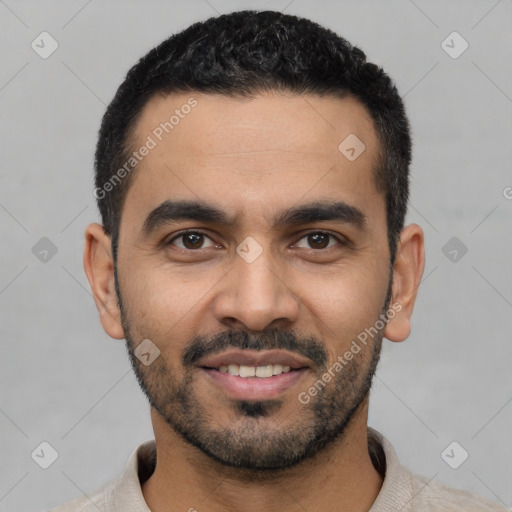 Joyful latino young-adult male with short  black hair and brown eyes