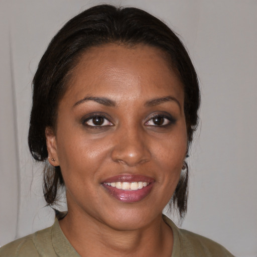 Joyful black young-adult female with medium  brown hair and brown eyes