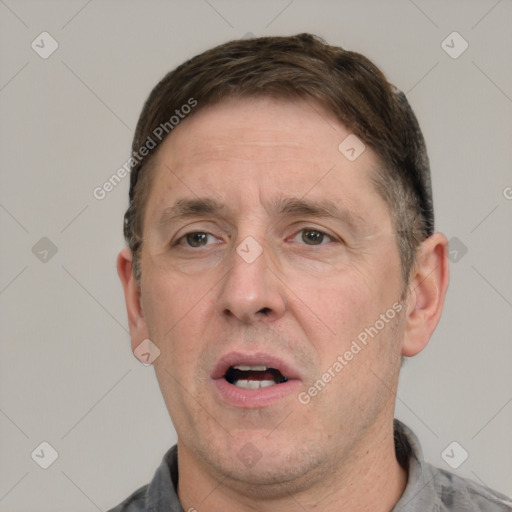 Joyful white adult male with short  brown hair and grey eyes