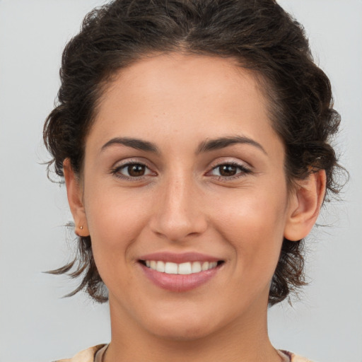 Joyful white young-adult female with medium  brown hair and brown eyes