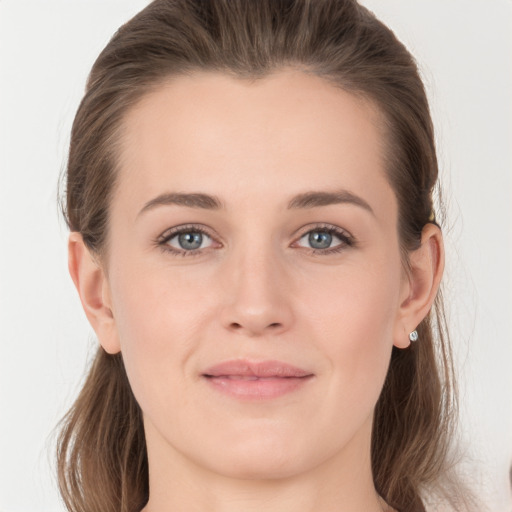 Joyful white young-adult female with long  brown hair and grey eyes