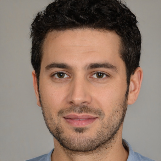 Joyful white young-adult male with short  black hair and brown eyes