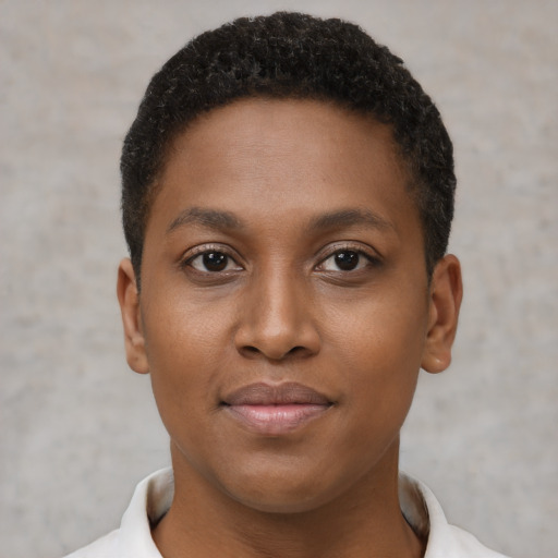 Joyful black young-adult female with short  brown hair and brown eyes