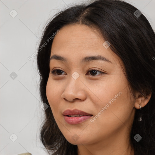 Joyful asian young-adult female with long  brown hair and brown eyes