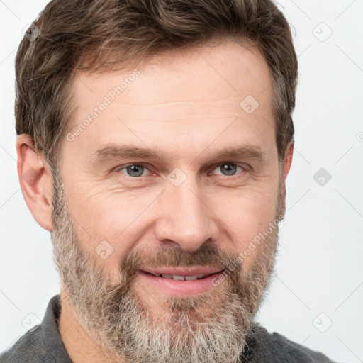 Joyful white adult male with short  brown hair and grey eyes