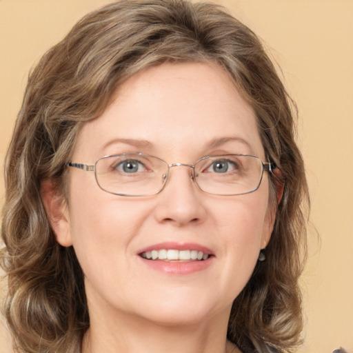 Joyful white adult female with medium  brown hair and green eyes