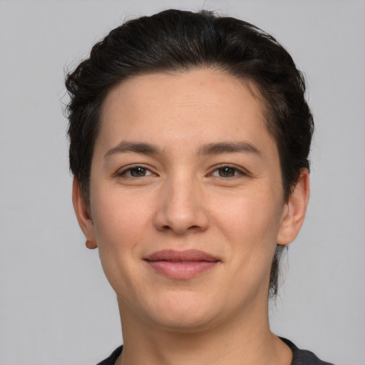 Joyful white young-adult female with short  brown hair and brown eyes