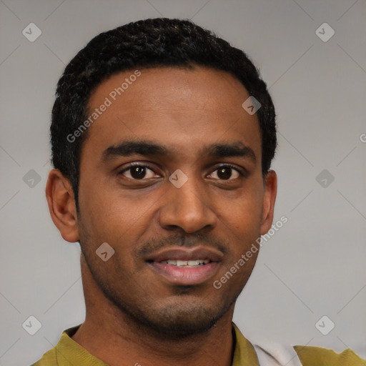 Joyful black young-adult male with short  black hair and brown eyes