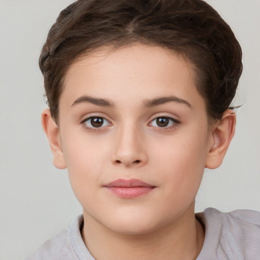 Joyful white child female with short  brown hair and brown eyes