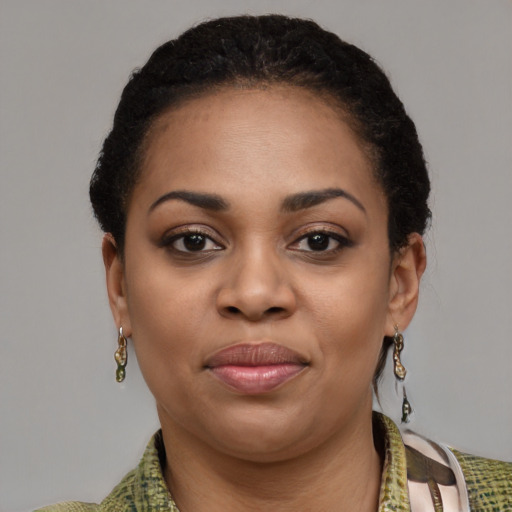 Joyful black young-adult female with short  brown hair and brown eyes