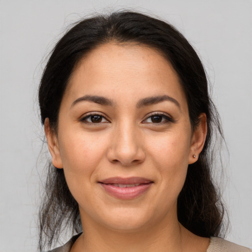 Joyful latino young-adult female with medium  brown hair and brown eyes