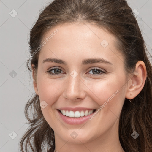 Joyful white young-adult female with long  brown hair and grey eyes