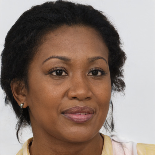 Joyful black adult female with medium  brown hair and brown eyes