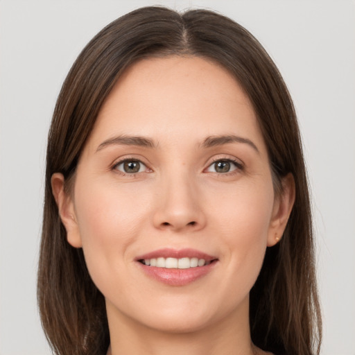 Joyful white young-adult female with long  brown hair and brown eyes