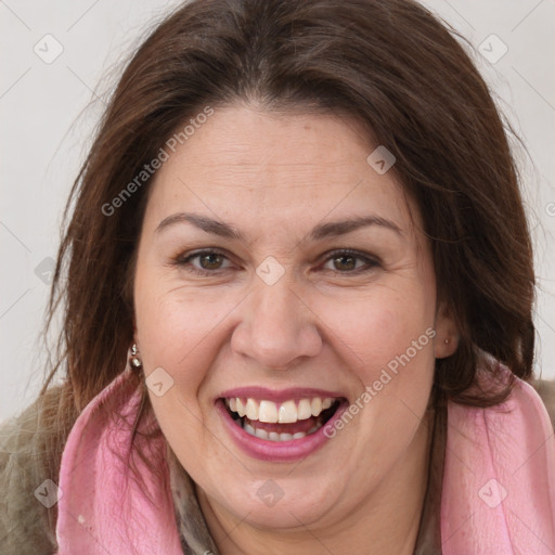 Joyful white adult female with long  brown hair and brown eyes