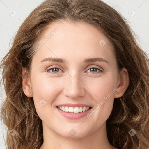 Joyful white young-adult female with long  brown hair and green eyes