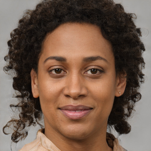Joyful black young-adult female with medium  brown hair and brown eyes