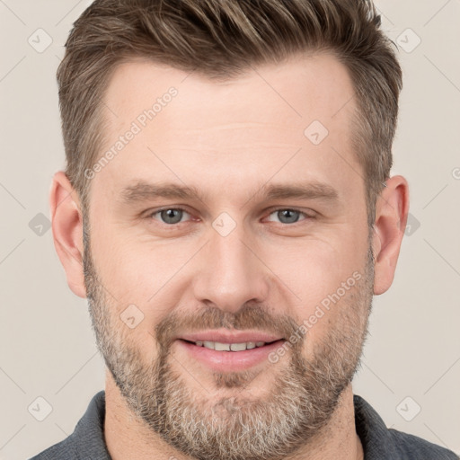 Joyful white young-adult male with short  brown hair and grey eyes