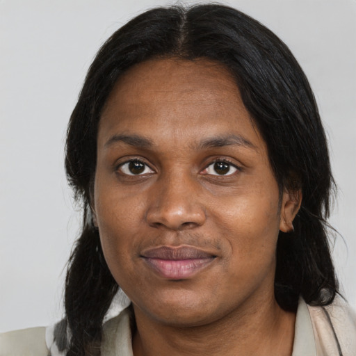Joyful black adult female with medium  black hair and brown eyes