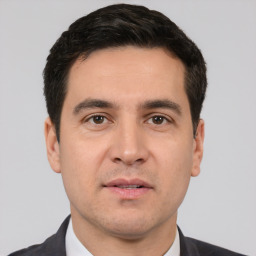 Neutral white young-adult male with short  black hair and brown eyes