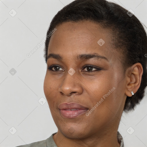 Joyful black young-adult female with short  black hair and brown eyes