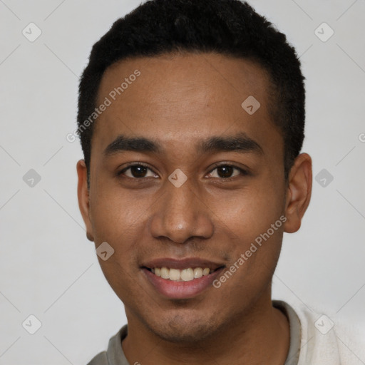 Joyful black young-adult male with short  brown hair and brown eyes