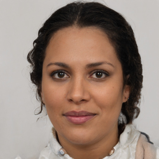 Joyful latino young-adult female with medium  brown hair and brown eyes