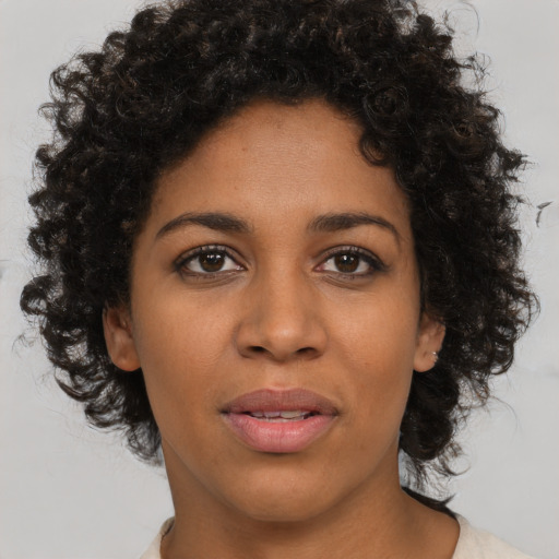 Joyful black young-adult female with medium  brown hair and brown eyes