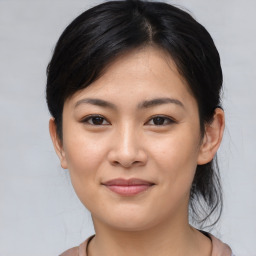 Joyful asian young-adult female with medium  brown hair and brown eyes