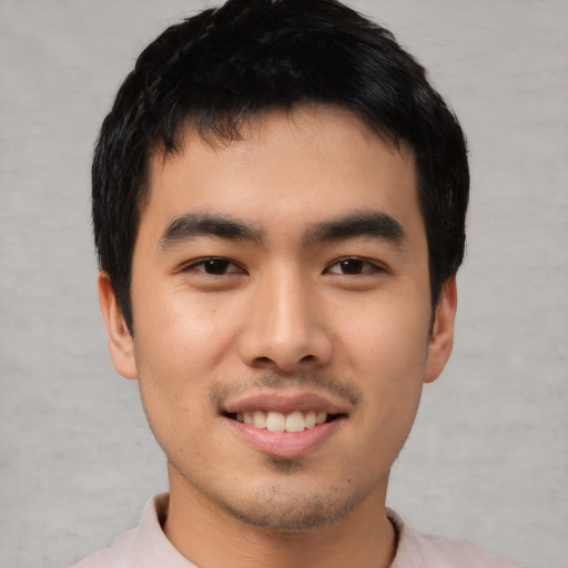 Joyful asian young-adult male with short  black hair and brown eyes