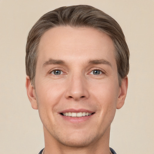 Joyful white adult male with short  brown hair and grey eyes