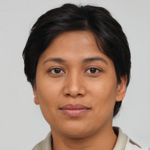 Joyful asian young-adult female with short  brown hair and brown eyes