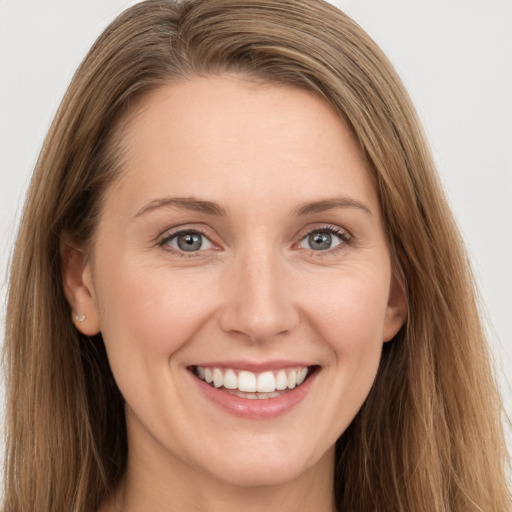 Joyful white young-adult female with long  brown hair and grey eyes