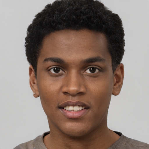 Joyful black young-adult male with short  brown hair and brown eyes