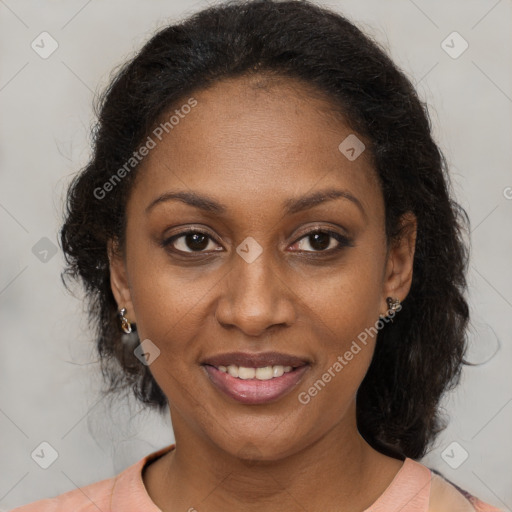 Joyful black adult female with medium  brown hair and brown eyes