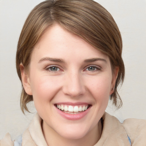 Joyful white young-adult female with medium  brown hair and blue eyes