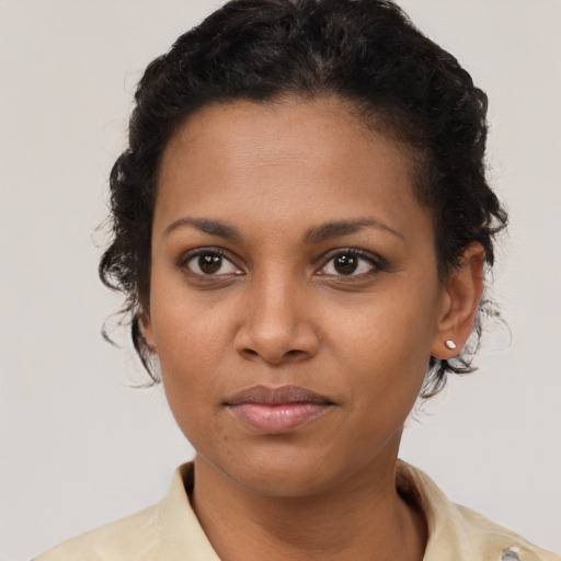 Joyful latino young-adult female with short  brown hair and brown eyes