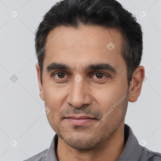 Joyful white adult male with short  black hair and brown eyes